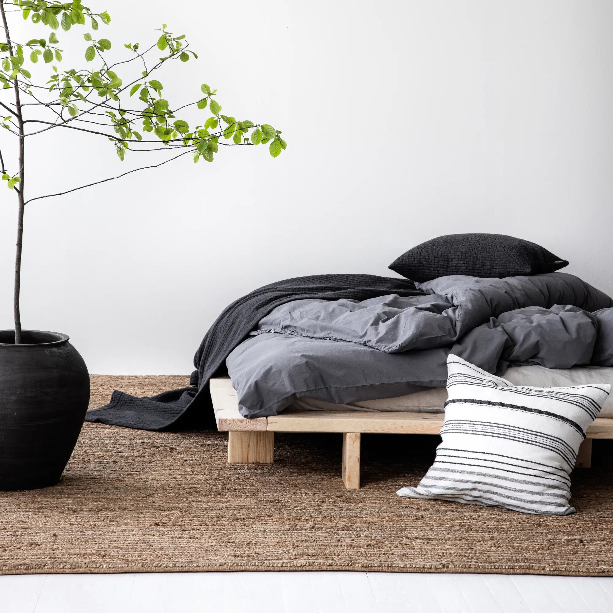 Solid wood Japan Bed with a raw, natural finish, perfect for a minimalist bedroom aesthetic