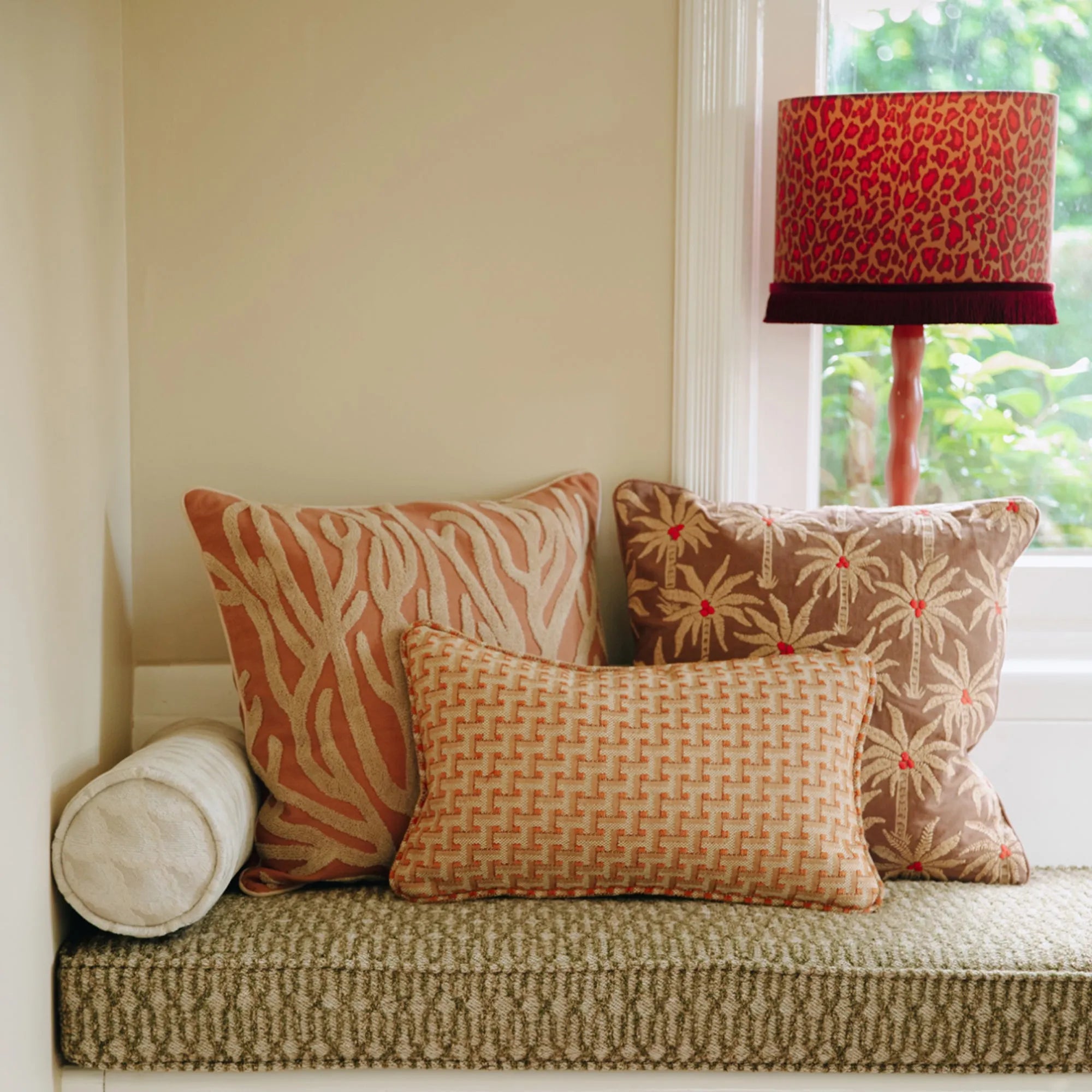 A close-up of a Laura Cushion in a soft, textured fabric with tassels