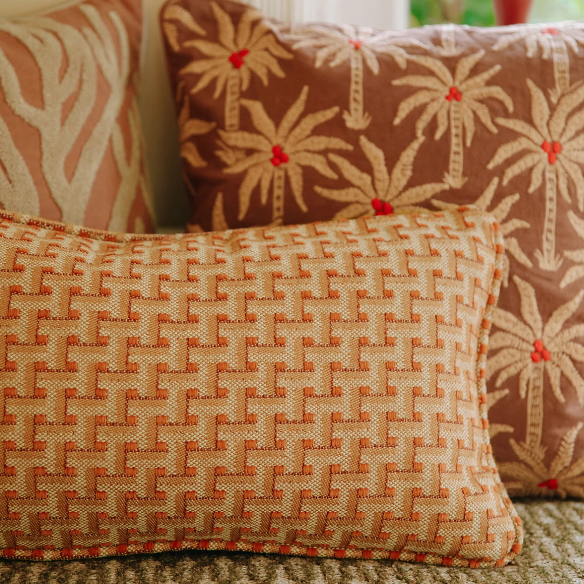 Laura Cushion displayed on a patio chair in a lush outdoor setting