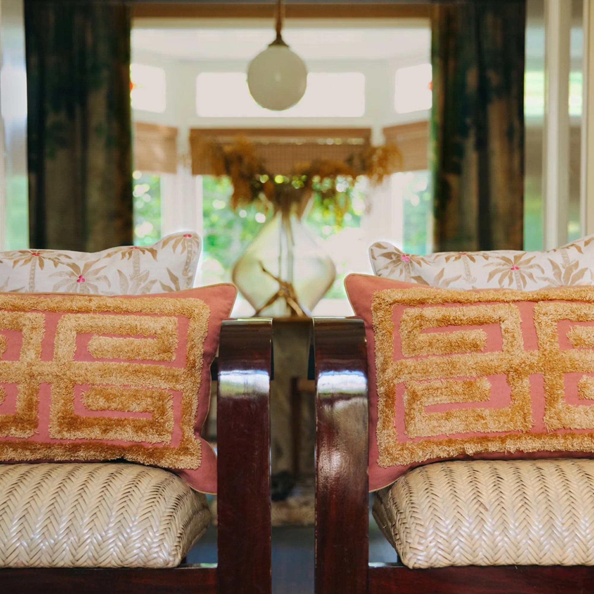 A close-up of a luxurious velvet Laura Cushion in a deep emerald green