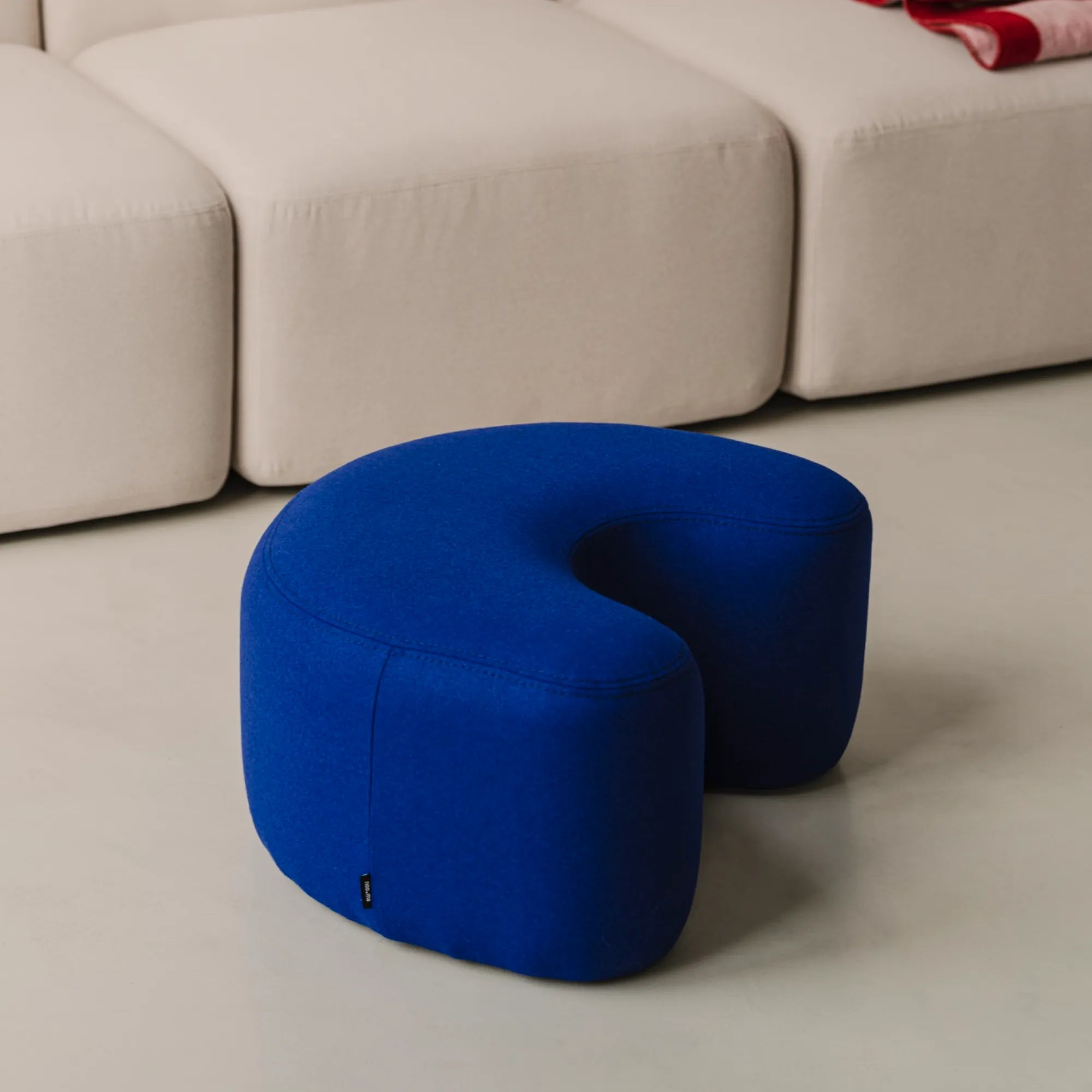 Versatile grey round Ü Pouf for extra seating or footrest in living room