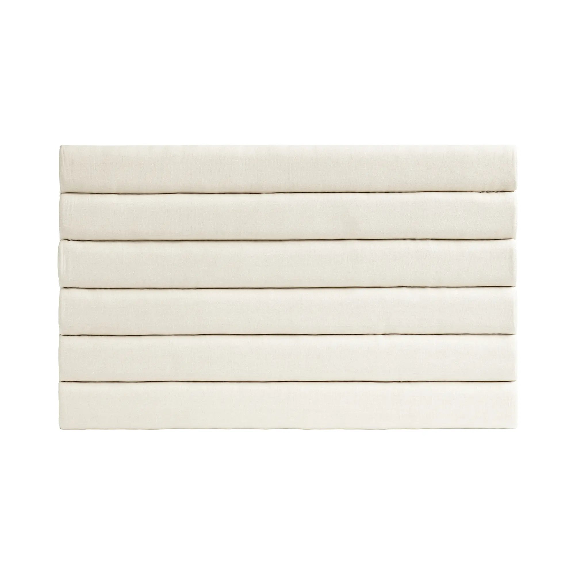 A luxurious linen headboard in a soft, neutral color with elegant tufting