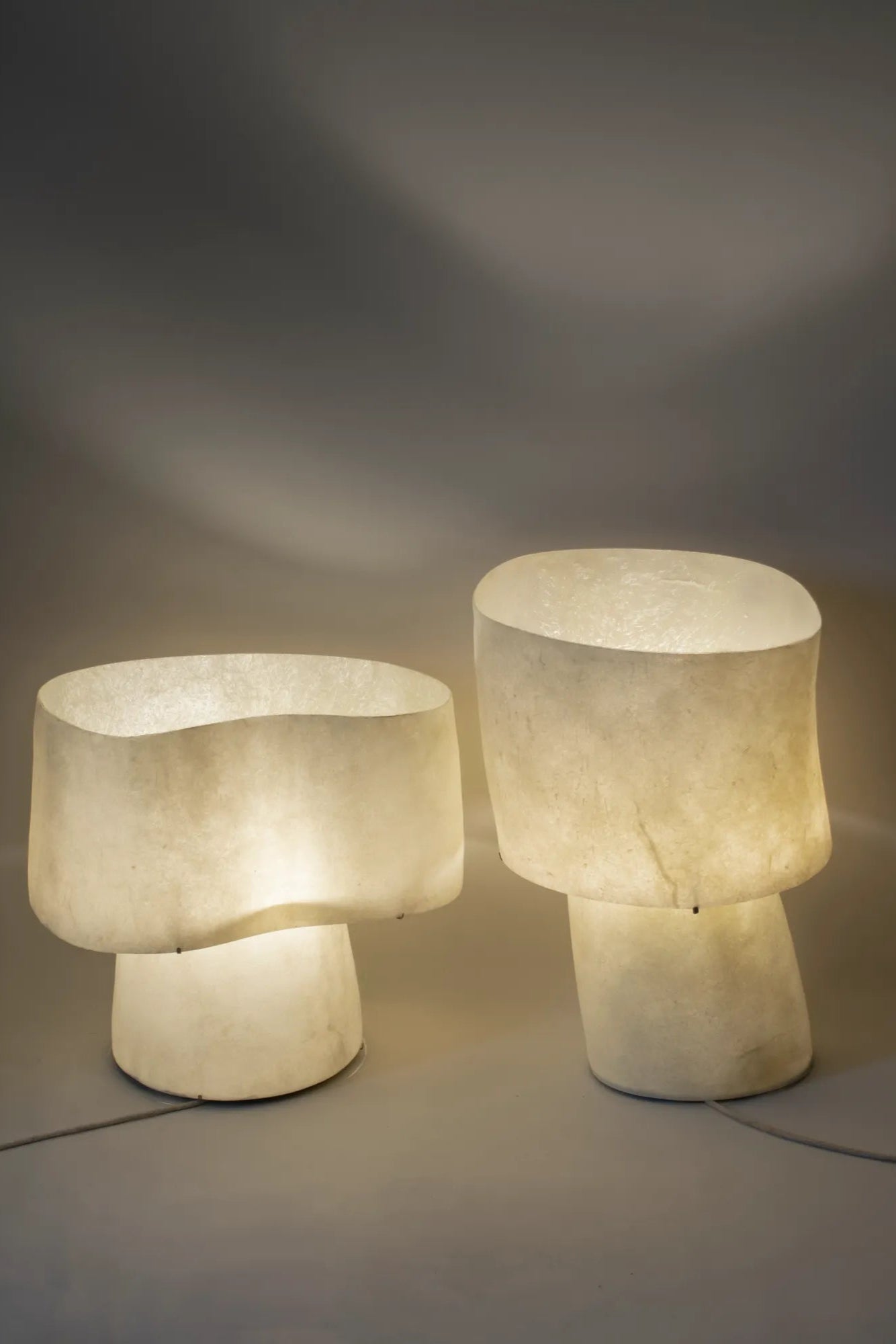 The “Mush” Lamp (Chub) emitting warm, ambient light in a modern office space