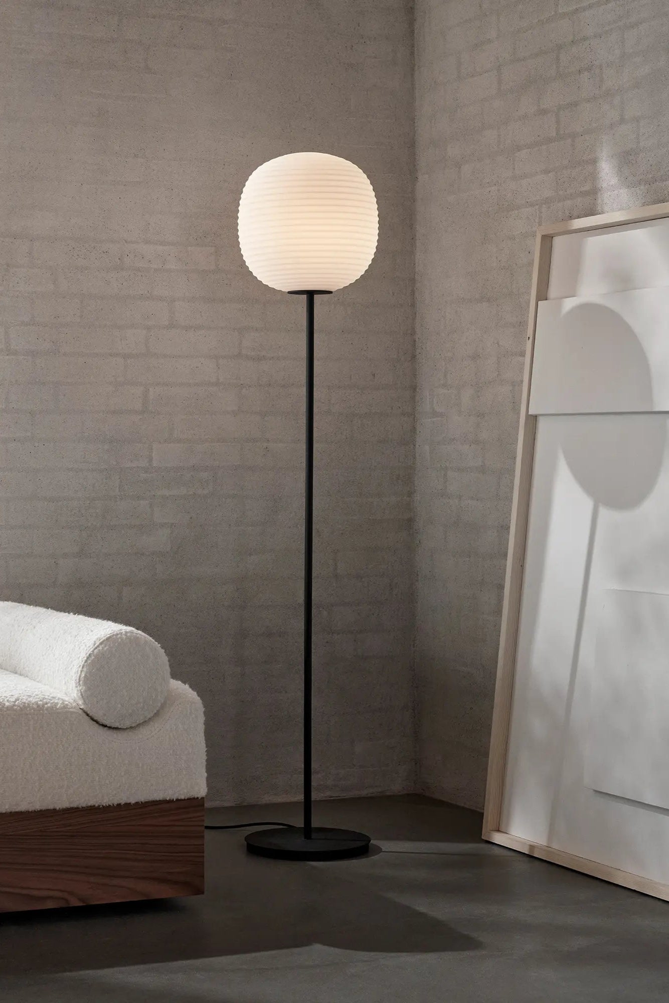 Lantern floor lamp standing tall in a modern living room