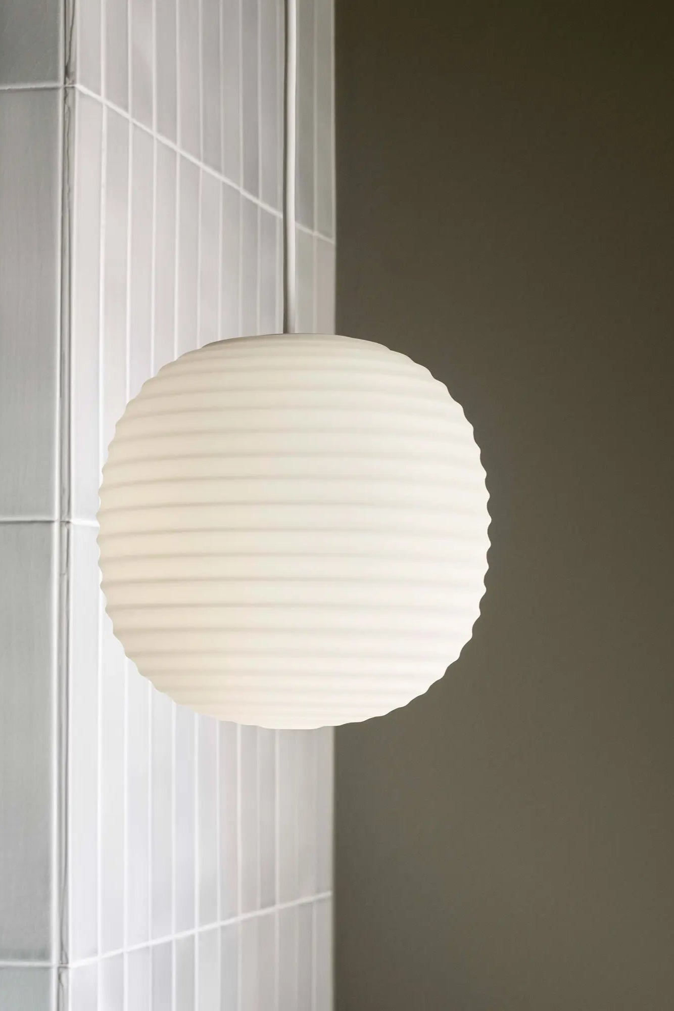Lantern Pendant Lamp casting a warm glow in a contemporary kitchen