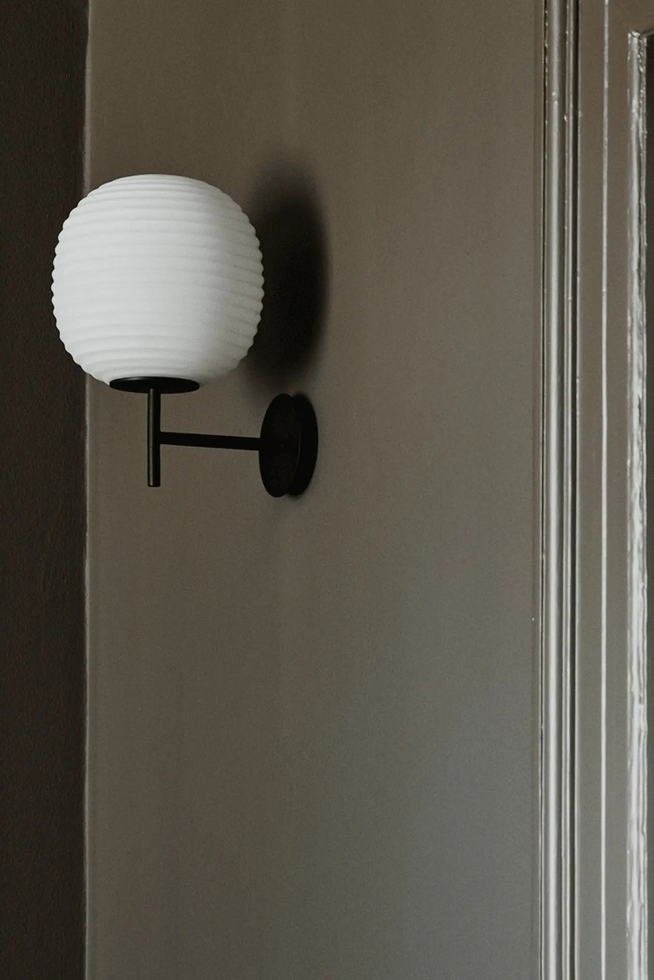 Lantern Wall Lamp featuring classic design with adjustable arm and clear glass panels
