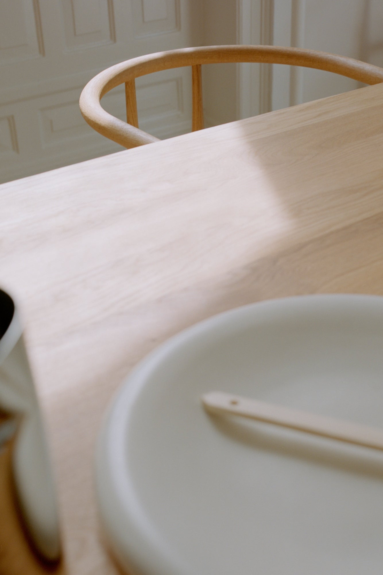 Modern and elegant Atlas dining table with sleek wood finish and unique base design