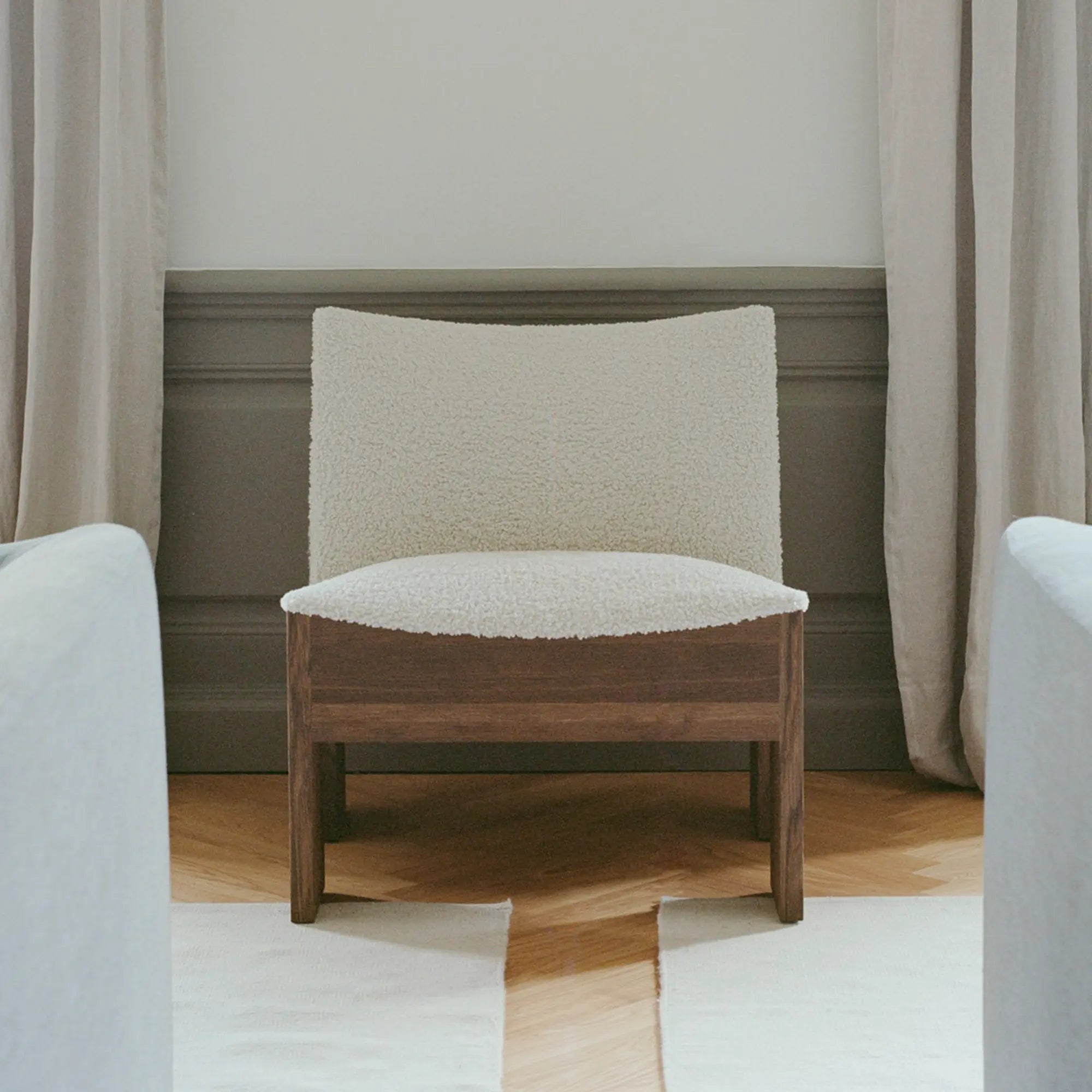  Side view of Tenon armchair showcasing its sleek and elegant design