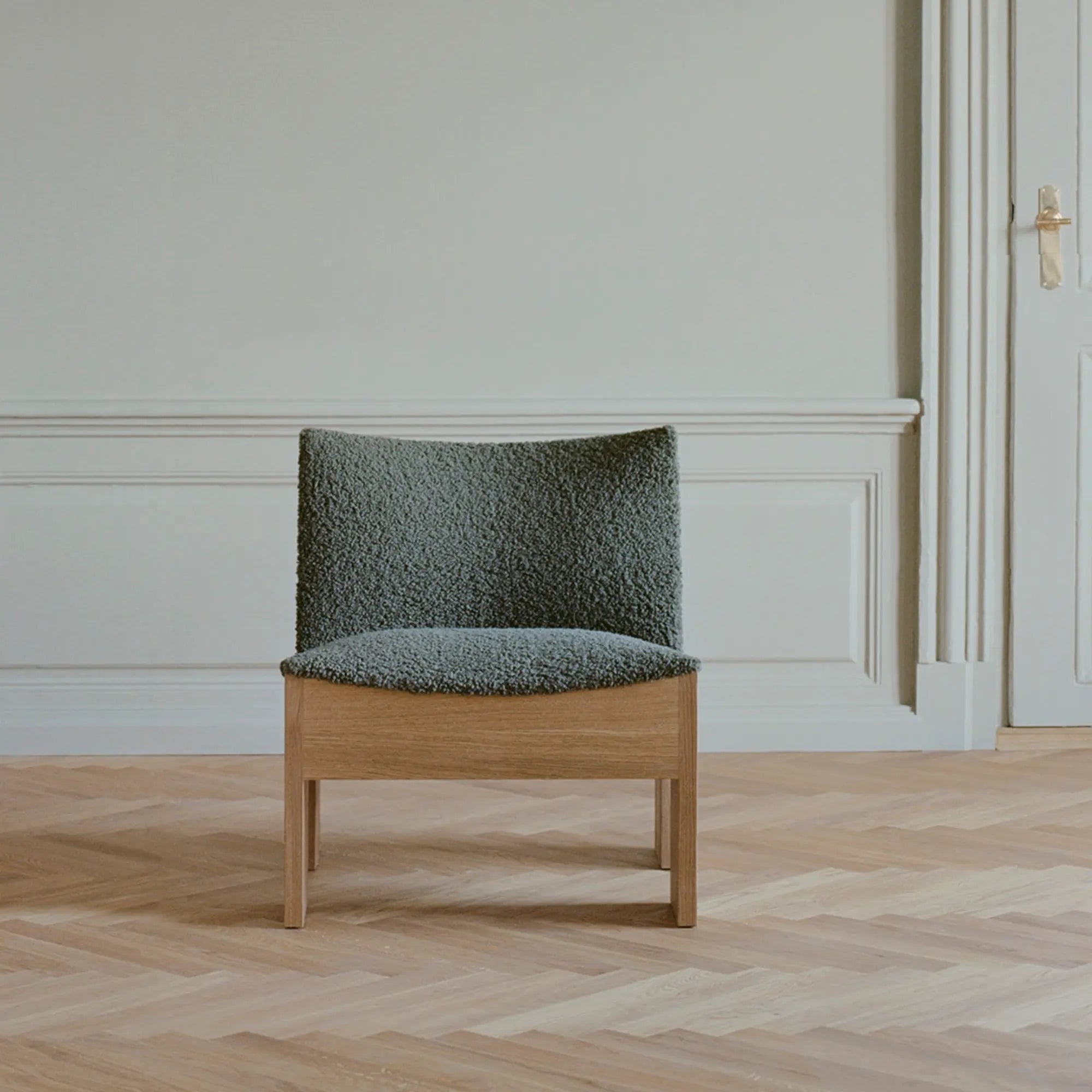 Close-up of Tenon Armchair's sturdy wooden frame and elegant design